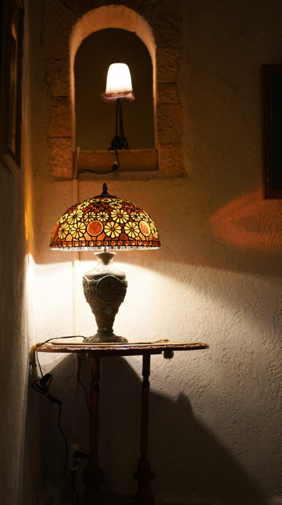 Low-level amber lighting in a healing sanctuary corner to signal the nervous system to rest.
