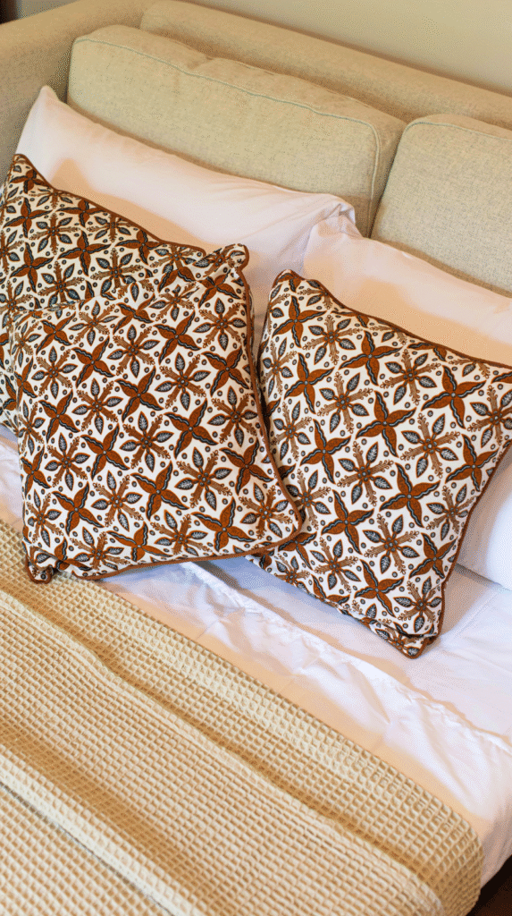 Close up of afrohemian decor mudcloth pillows and textured rugs.
