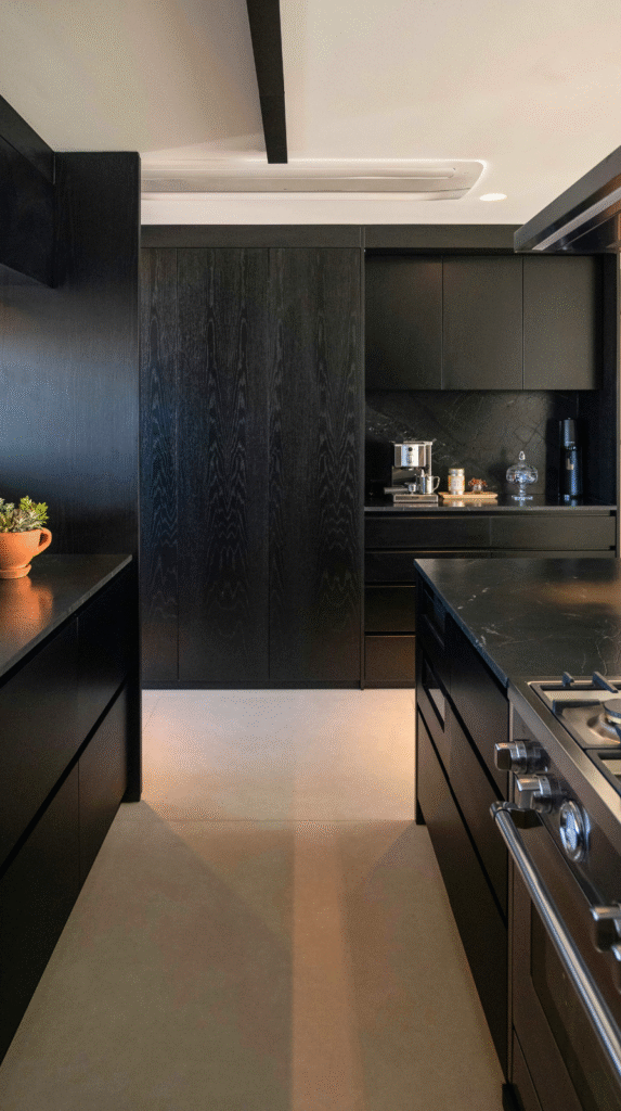 A modern kitchen featuring natural wood cabinetry and terracotta decor accents
